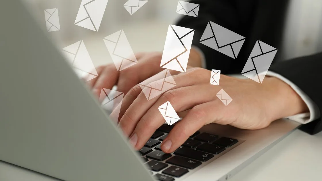 A small business owner reviewing an email marketing campaign on a laptop