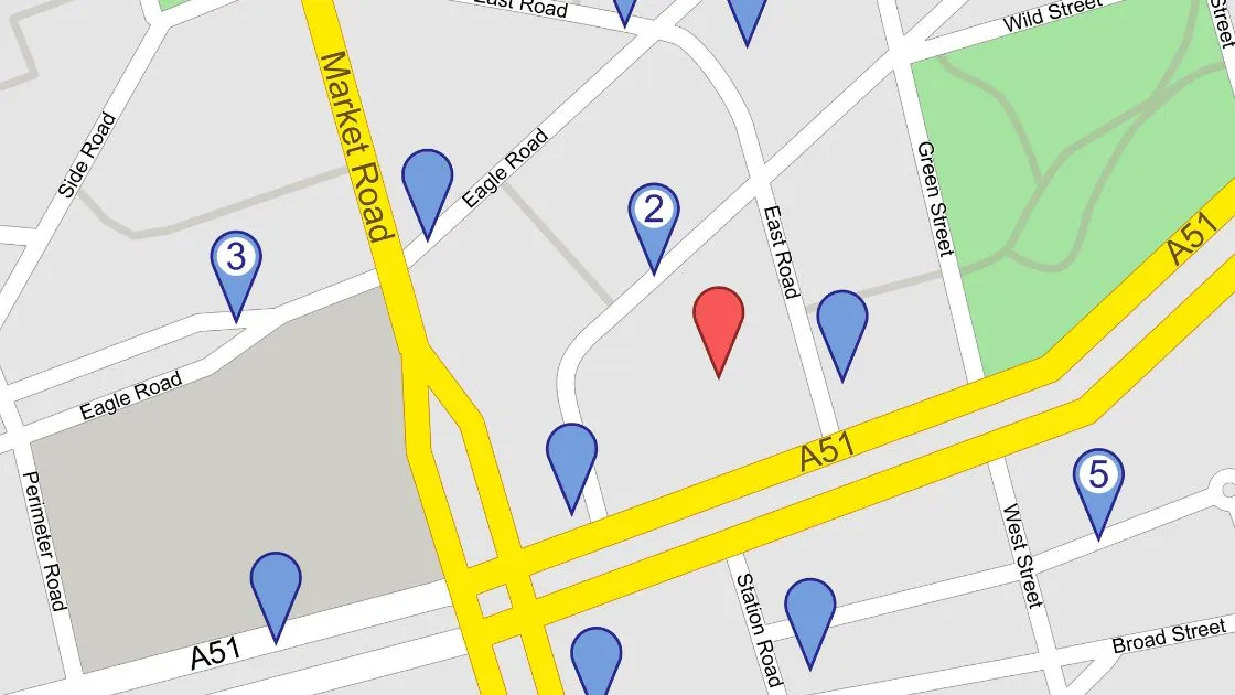 A street map with blue location pins and one red pin marking a local business